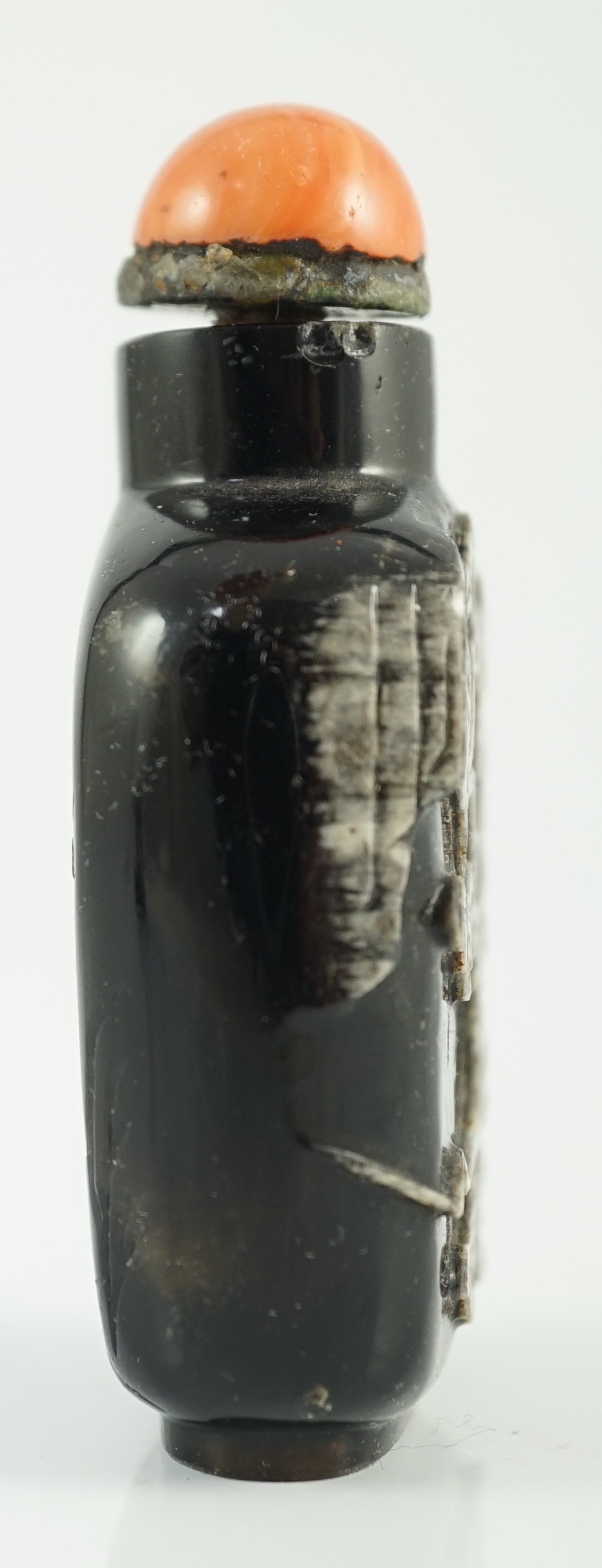 A Chinese smoky quartz snuff bottle, 1780-1820, 6.7cm high, coral stopper